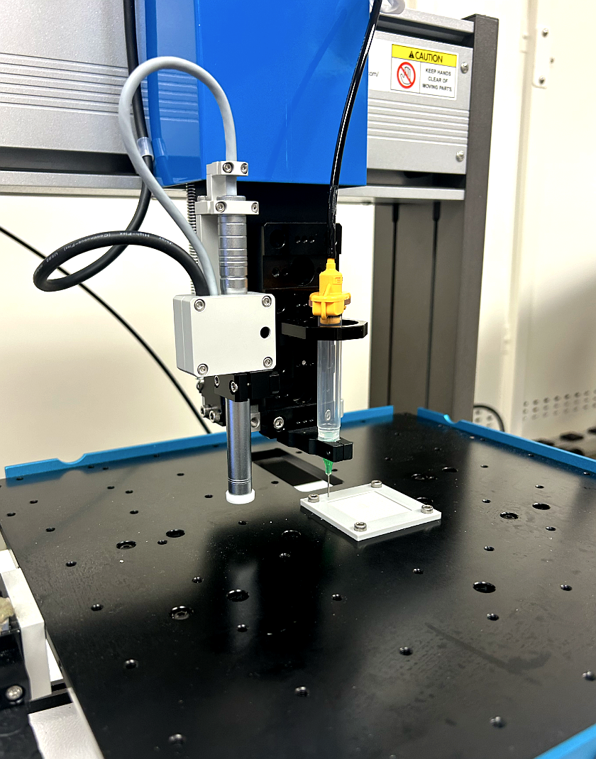 Nordson EFD E3V robot dispensing UV adhesive on hollow fiber membrane mock sheet